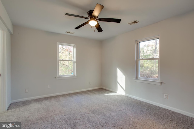 carpeted spare room with ceiling fan