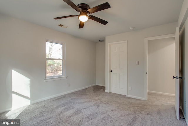 unfurnished bedroom featuring ceiling fan and light carpet