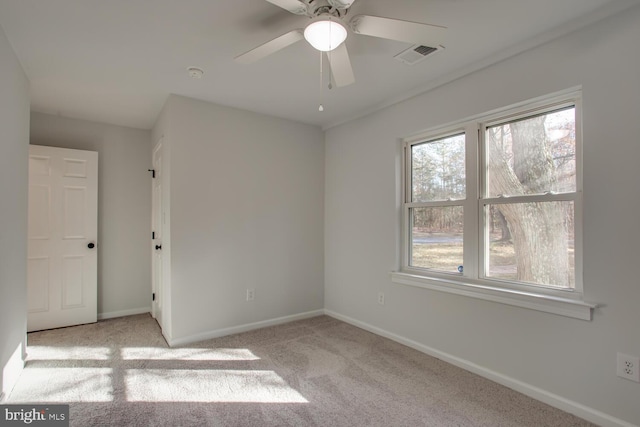 unfurnished room with light carpet and ceiling fan