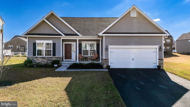 craftsman-style house featuring a garage and a front lawn