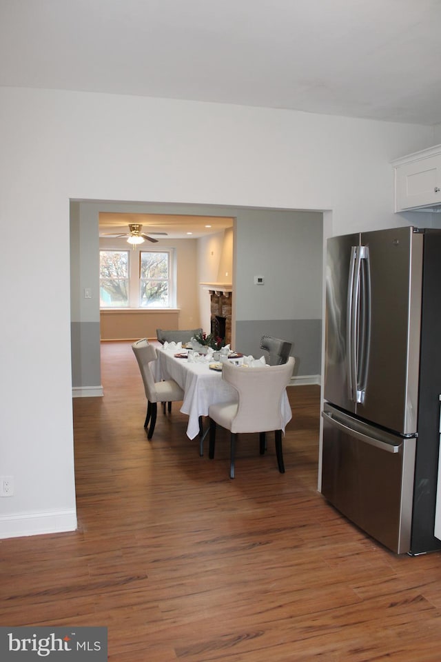 dining room featuring wood-type flooring and ceiling fan