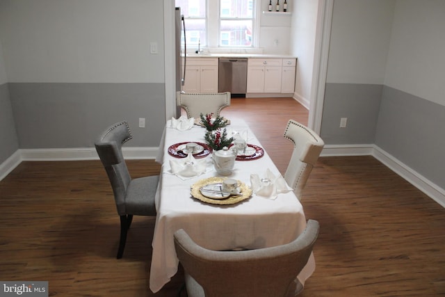 dining area featuring dark wood-type flooring