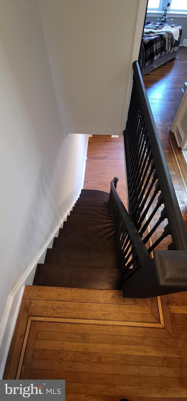 stairs featuring wood-type flooring