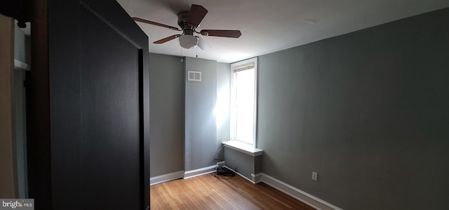 unfurnished room with ceiling fan, a healthy amount of sunlight, and light wood-type flooring