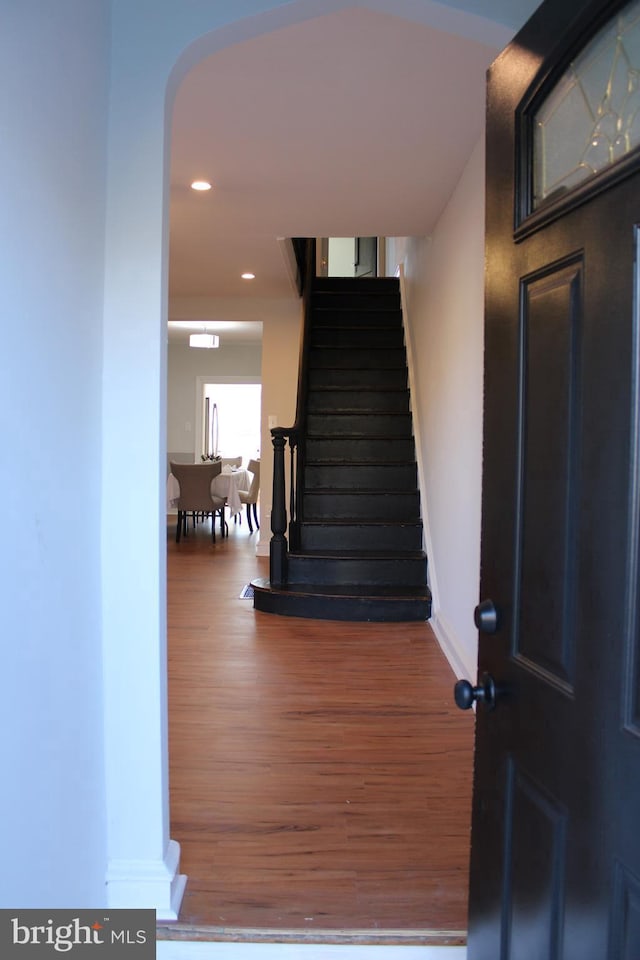 staircase with hardwood / wood-style floors