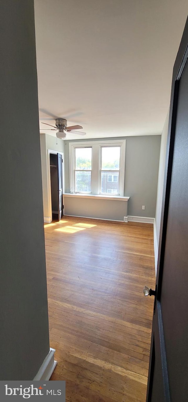 spare room with wood-type flooring and ceiling fan