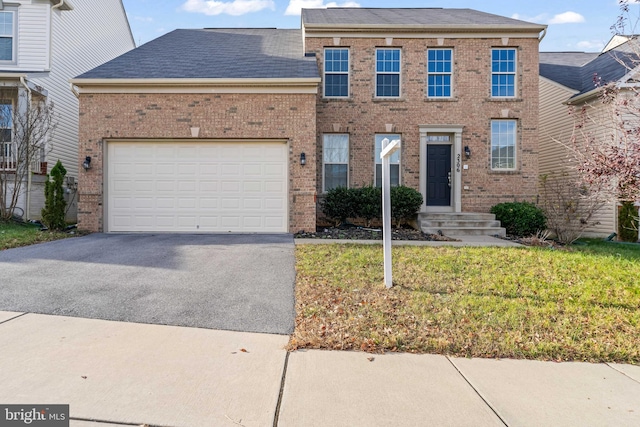 view of front of property featuring a garage and a front lawn