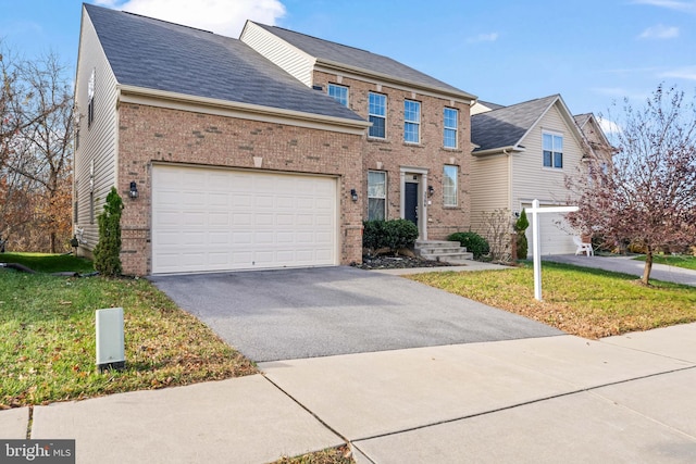 view of front of house featuring a front lawn and a garage