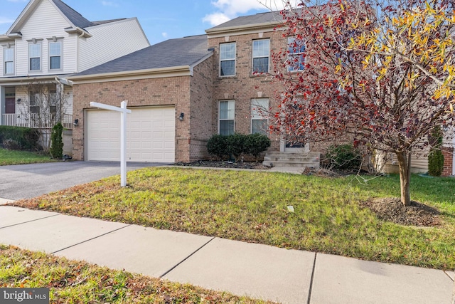 multi unit property with a front yard and a garage