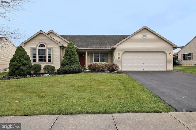 single story home featuring a garage and a front yard