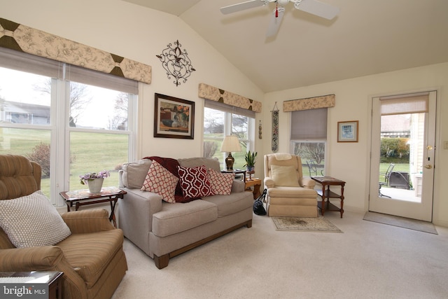 living room with ceiling fan, light colored carpet, and vaulted ceiling