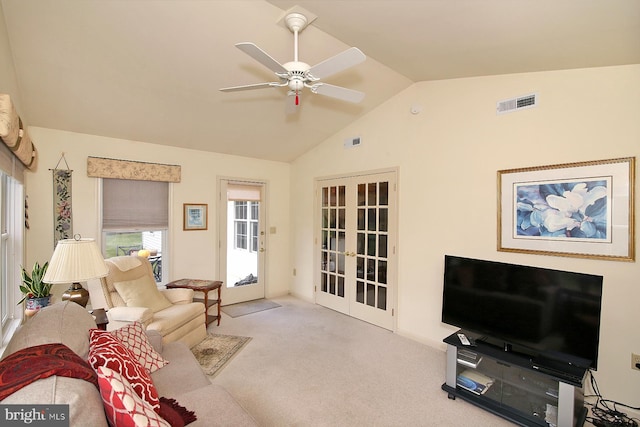 carpeted living room with ceiling fan, french doors, and lofted ceiling