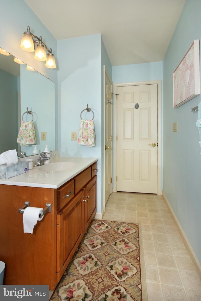 bathroom with tile patterned floors and vanity