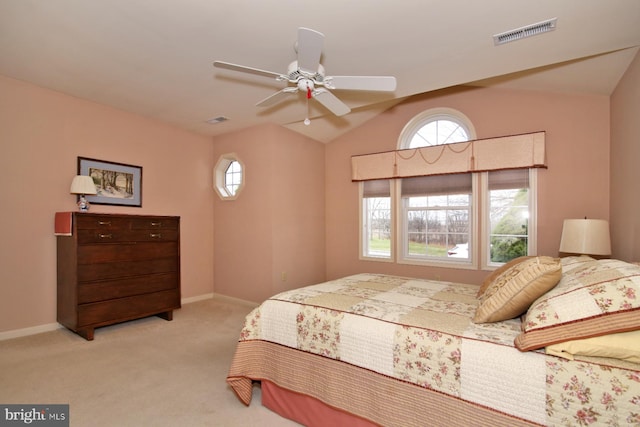 bedroom featuring light carpet, multiple windows, and ceiling fan