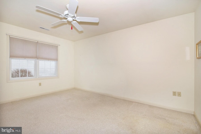 carpeted empty room featuring ceiling fan