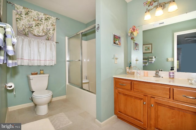 full bathroom with tile patterned floors, vanity, toilet, and bath / shower combo with glass door