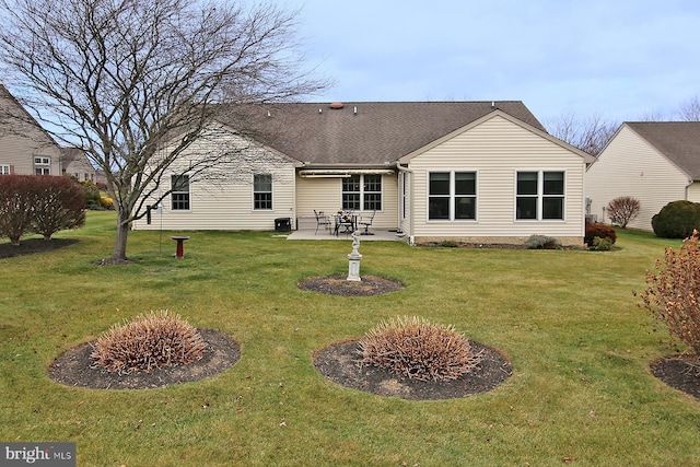 back of house with a patio area and a lawn