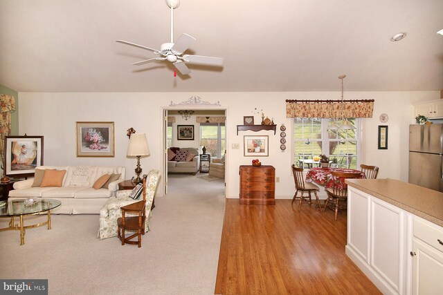 living room featuring ceiling fan and light hardwood / wood-style flooring