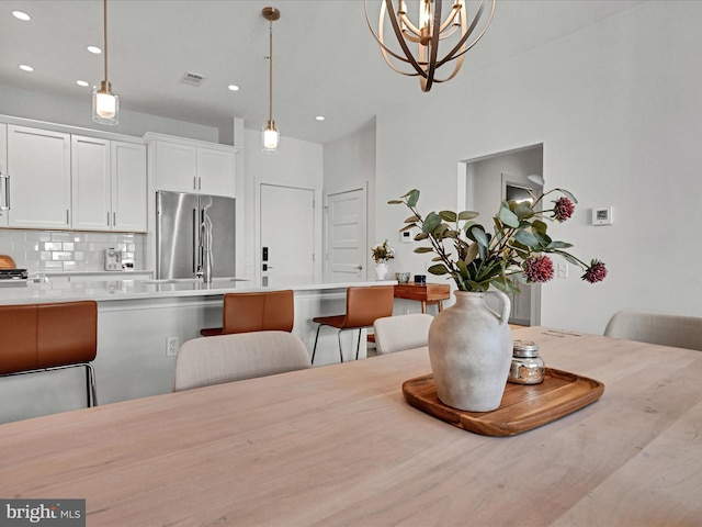 dining space with an inviting chandelier