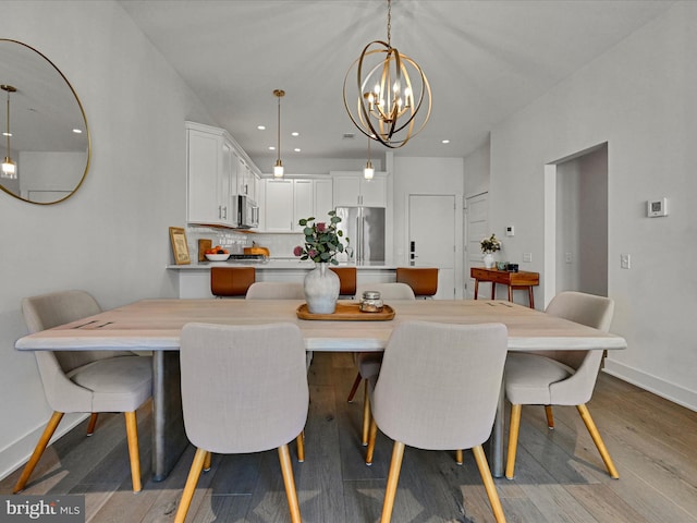 dining area featuring light hardwood / wood-style flooring and a notable chandelier