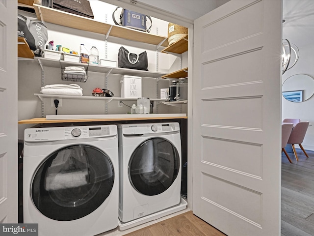 washroom featuring light hardwood / wood-style floors and washing machine and clothes dryer