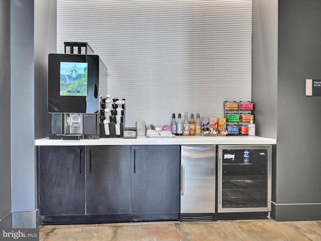 bar featuring wine cooler and stainless steel refrigerator