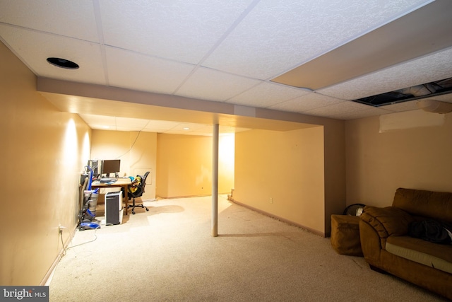 basement with carpet floors and a paneled ceiling