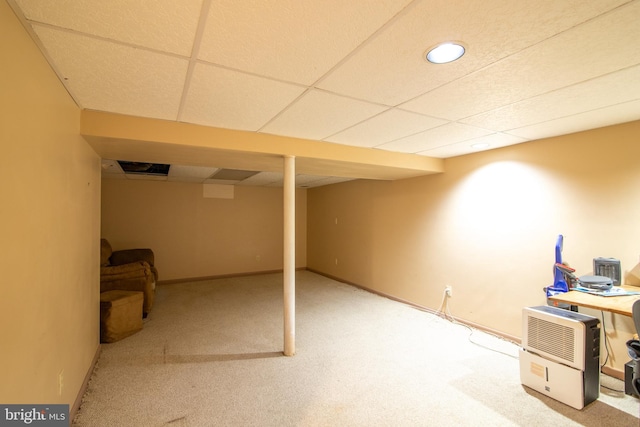 basement featuring carpet flooring and a drop ceiling