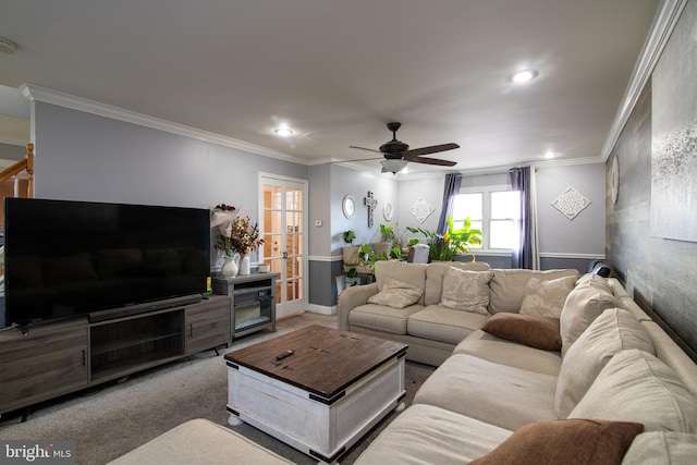 carpeted living room featuring ceiling fan and ornamental molding