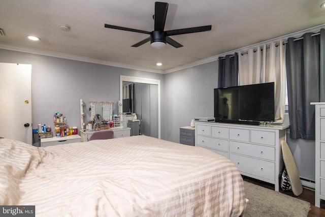 bedroom featuring ceiling fan, wood-type flooring, crown molding, and a closet