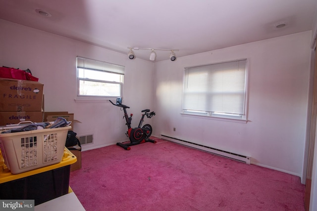 interior space featuring baseboard heating and carpet flooring