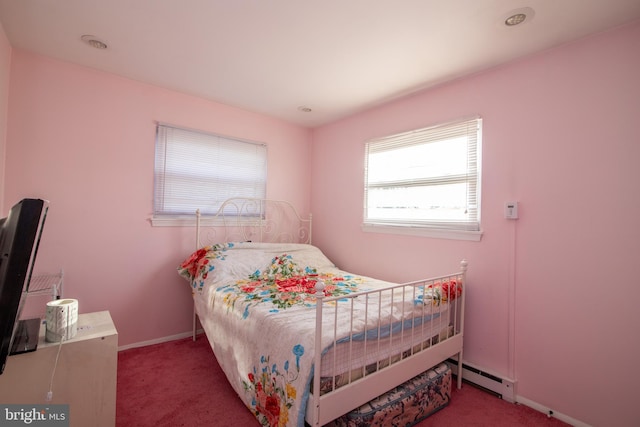 carpeted bedroom featuring a baseboard heating unit