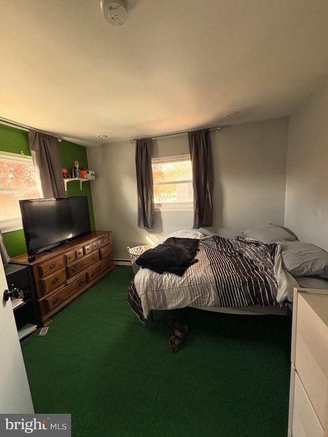 bedroom with carpet and baseboard heating