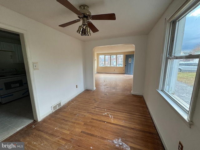 empty room featuring ceiling fan and hardwood / wood-style flooring