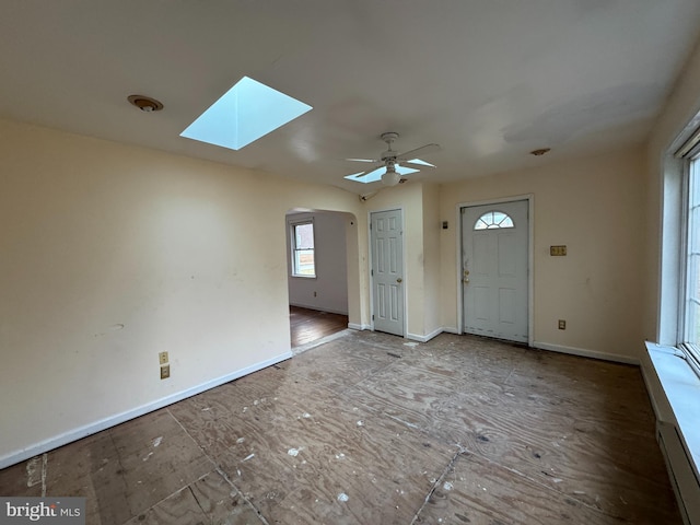 foyer featuring a skylight and ceiling fan