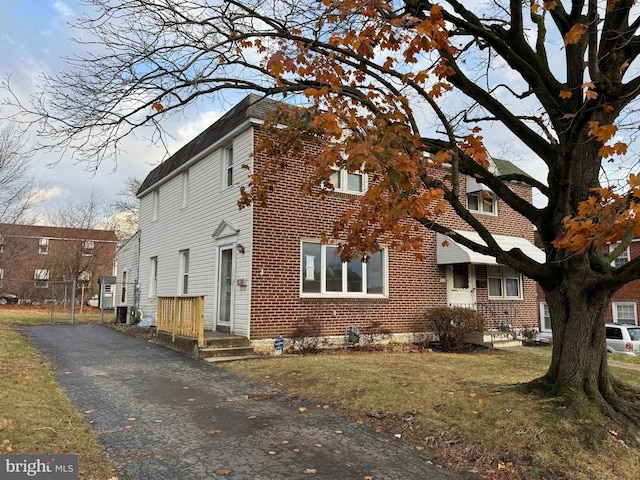 view of property exterior featuring a lawn and central AC unit