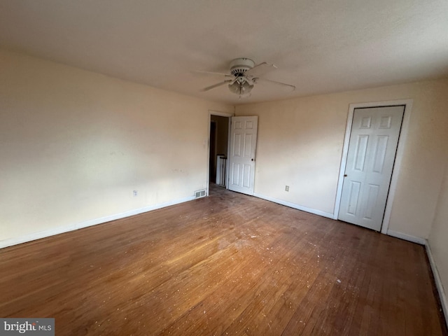 unfurnished bedroom with ceiling fan and wood-type flooring