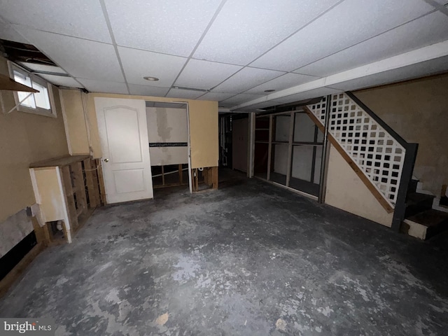 basement with a paneled ceiling