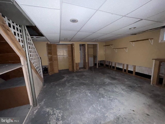 basement with a paneled ceiling