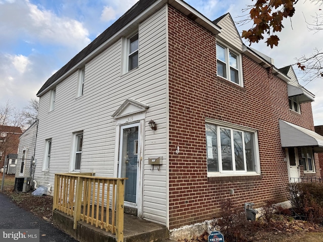 rear view of property featuring cooling unit