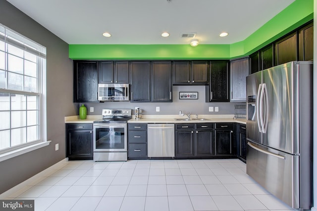 kitchen featuring dark brown cabinets, sink, and stainless steel appliances