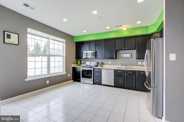 kitchen featuring light tile patterned floors, sink, and appliances with stainless steel finishes