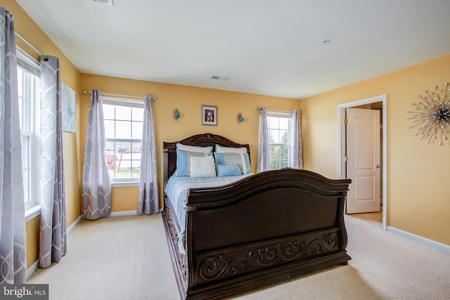 bedroom featuring light carpet