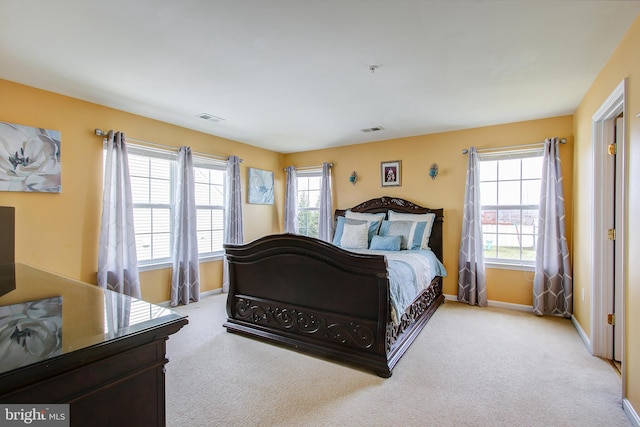 bedroom featuring light carpet