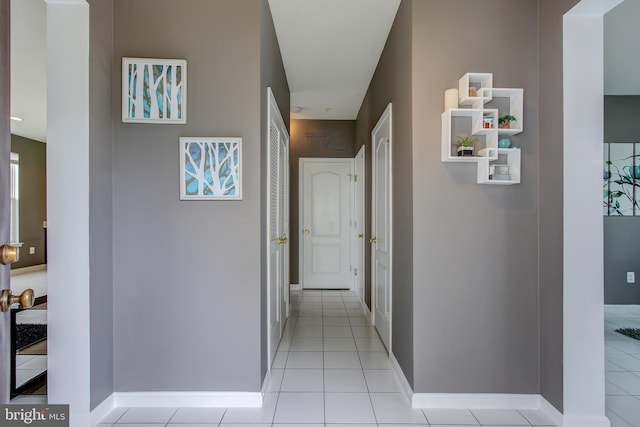 hall featuring light tile patterned floors