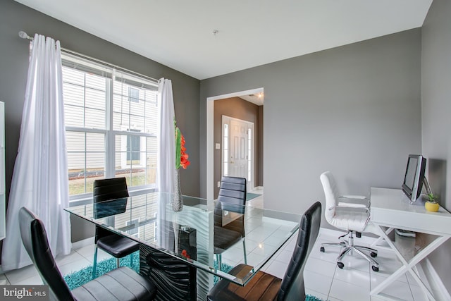 office space featuring plenty of natural light and light tile patterned flooring