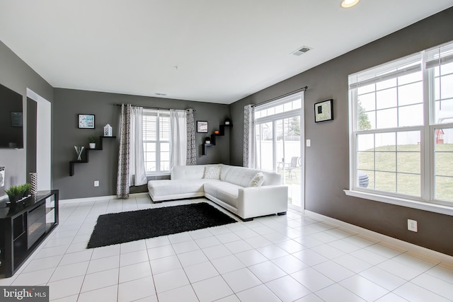 unfurnished living room with a wealth of natural light and light tile patterned floors