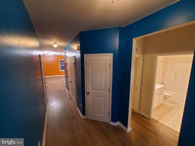 corridor featuring hardwood / wood-style floors