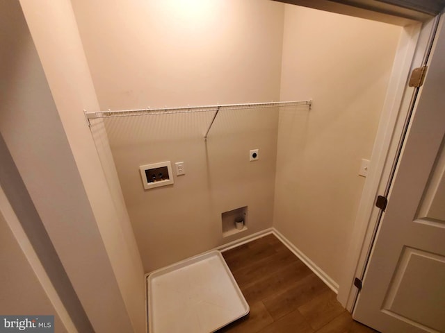 washroom with dark hardwood / wood-style flooring, washer hookup, and hookup for an electric dryer