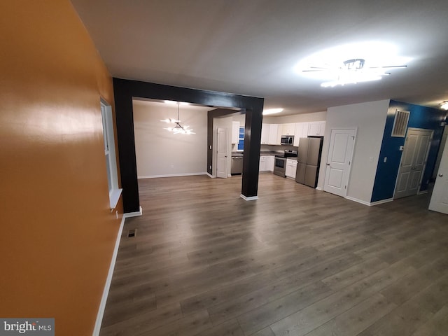 unfurnished living room featuring dark wood-type flooring